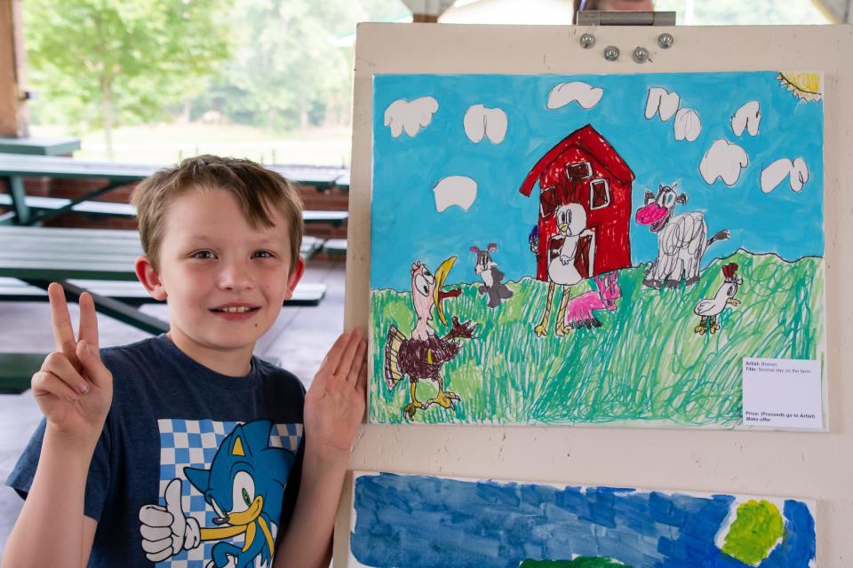 Braven shows off his picture "Normal Day on the Farm." Braven said the turkey was his favorite to draw.