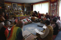 Jalue Dorje and his fellow monks pray during a ceremony paying homage to Guru Rinpoche, the Indian Buddhist master who brought Tantric Buddhism to Tibet, at Dorje's home in Columbia Heights, Minn., on Monday, July 19, 2021. Over two days the group prayed for victims of natural disasters, war and COVID-19, and for the peace and happiness of beings worldwide. (AP Photo/Jessie Wardarski)