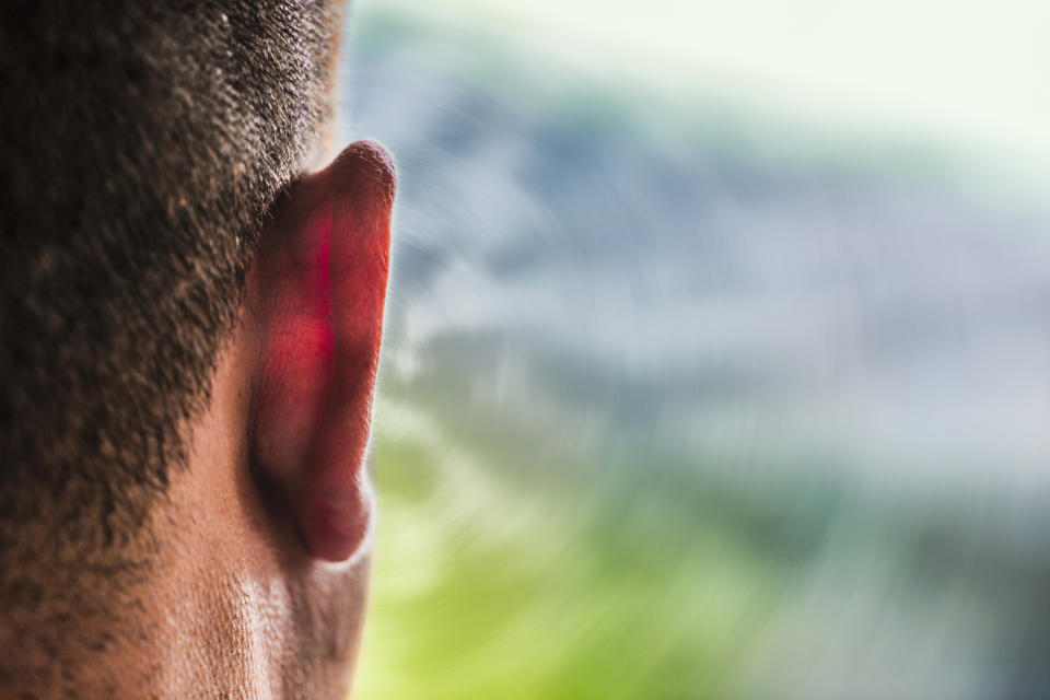 Close-up of a human ear with soft background, highlighting the intricacies of the ear's structure