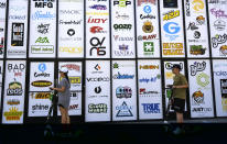 FILE - This Aug. 28, 2019, file photo shows advertising logos for different cannabis brands posted on the side of a shop on a street lined with wholesale cannabis vape shops in downtown Los Angeles. The vape cartridges that go by the catchy, one-syllable name “Dank” - a slang word for highly potent cannabis - are figuring prominently in the federal investigation to determine what has caused a rash of mysterious and sometimes fatal lung illnesses apparently linked to vaping. The raw materials to produce a Dank vape aren’t hard to find as you can order them from Chinese internet sites or buy the boxes and empty cartridges in shops in Los Angeles. (AP Photo/Richard Vogel, File)