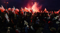 <p>Demonstrators burn flares and wave Polish flags during the annual march to commemorate Poland’s National Independence Day in Warsaw, Poland, Saturday, Nov. 11, 2017. (Photo: Czarek Sokolowski/AP) </p>