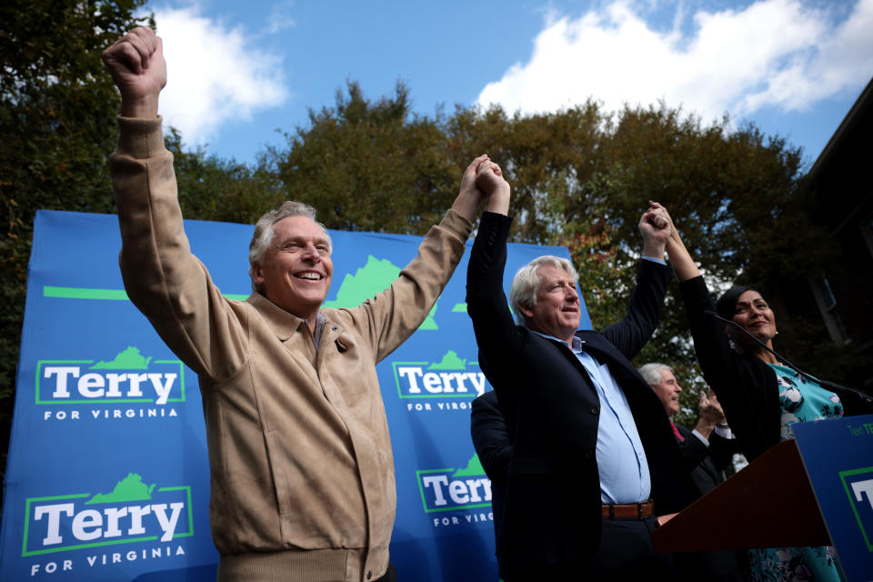 Democratic gubernatorial candidate Terry McAuliffe, Democratic candidate for Attorney General Mark Herring, and Democratic candidate for Lieutenant Governor Hala Ayala finish speaking to supporters at a campaign event.