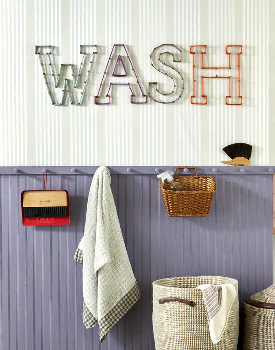 <p>Gussy up the laundry room or a kids’ bath with appropriate words like “wash” or “splash.” Start by cutting out letters from craft paper. Mark nail holes with a pencil on the wall using the letters as a guide. Hammer copper nails into the wall, and wrap nails with lengths of assorted-colored thick yarn. </p>