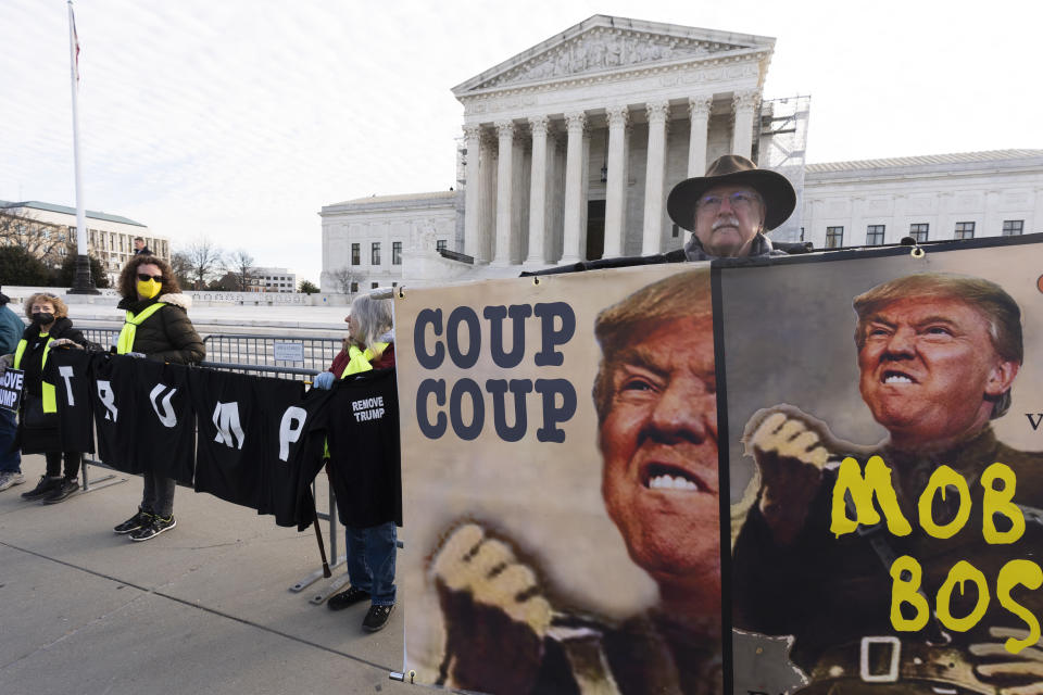 Protesters hold their banners in front of the U.S. Supreme Court, Thursday, Feb. 8, 2024, in Washington. (AP Photo/Manuel Balce Ceneta)