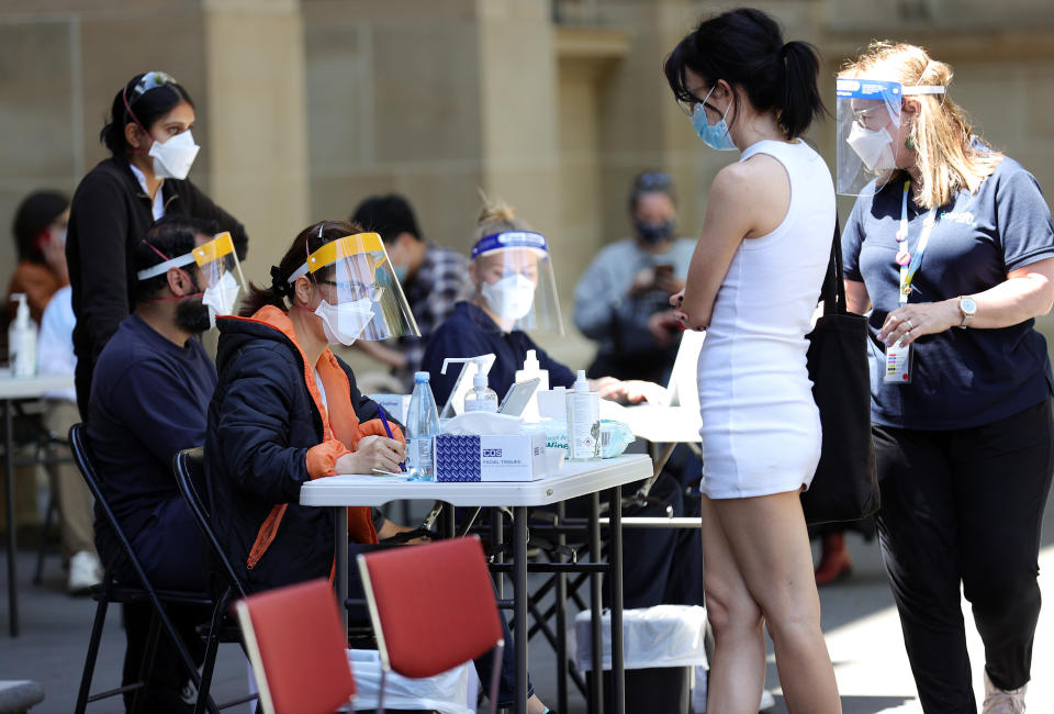 People are seen at a Cohealth pop-up vaccination clinic at the State Library Victoria, in Melbourne, Monday. Source: AAP