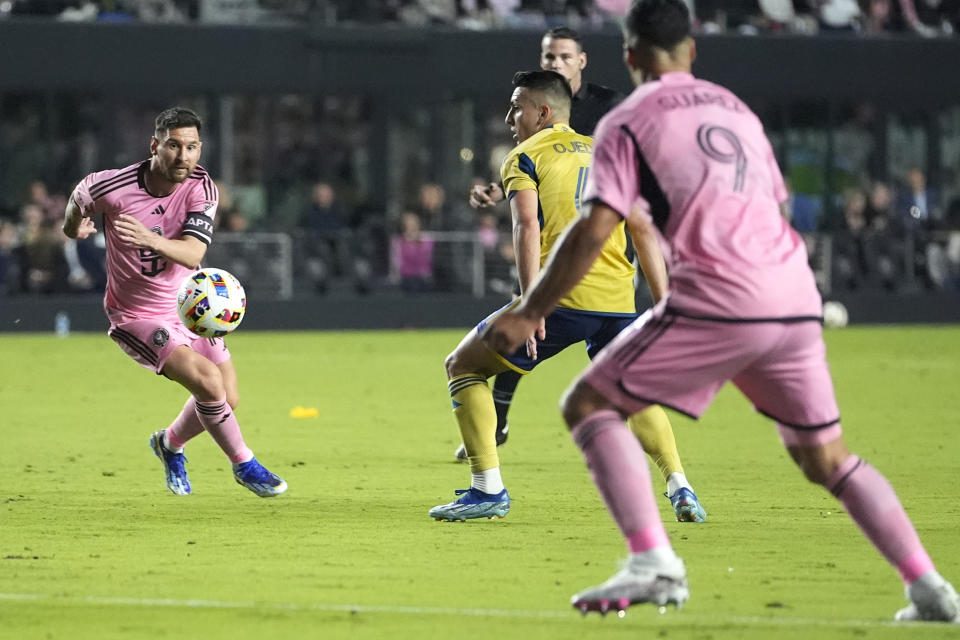 Inter Miami forward Lionel Messi, left, passes the ball to forward Luis Suarez (9) during the first half of the team's MLS soccer match against Real Salt Lake, Wednesday, Feb. 21, 2024, in Fort Lauderdale, Fla. (AP Photo/Lynne Sladky)