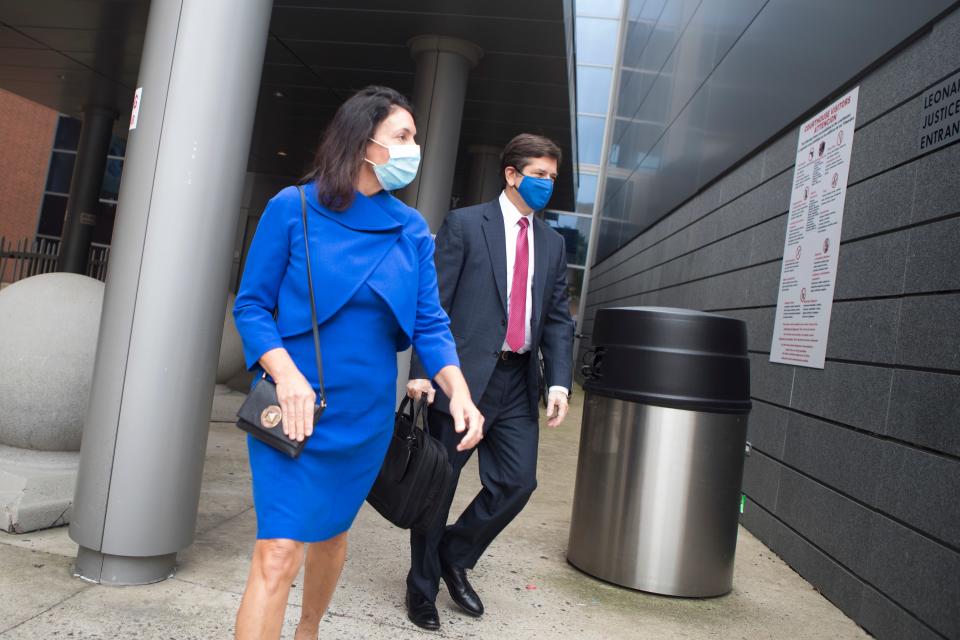 Delaware state Auditor Kathy McGuiness, left, leaves the New Castle County Courthouse with her attorney Steve Wood Tuesday, Oct. 12, 2021. McGuiness was indicted Monday on criminal charges that she hired and supervised her daughter in a do-nothing state job, that she circumvented state contracting laws to shield public payments to a political campaign group from regulator scrutiny and that she spied on and discriminated against employees who questioned her conduct.