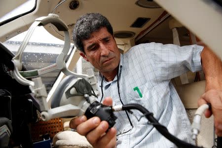 Pilot Nicolas Veloz prepares for takeoff in a private plane at Charallave airport outside Caracas September 15, 2014. REUTERS/Carlos Garcia Rawlins