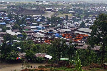 Backhoes, trucks and machinery are parked in a company compound near a jade mine in Hpakant township, Kachin State July 8, 2013. REUTERS/Minzayar