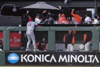 Cincinnati Reds center fielder Nick Senzel (15) watches as a fan catches a solo home run by San Francisco Giants' Evan Longoria during the fourth inning of a baseball game in San Francisco, Friday, June 24, 2022. (AP Photo/John Hefti)