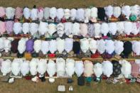 Around 1,000 residents of Pekanbaru in Indonesia held a prayer in an open field as a thick, acrid fog drifted around them