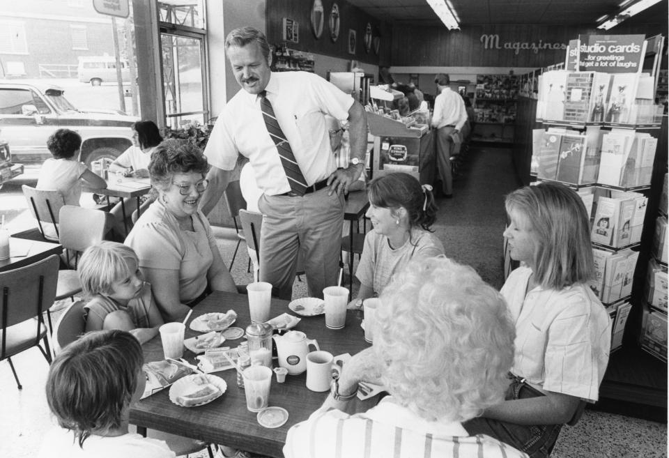 Jim Peck talks with customers at Long's Drug Store in 1985.