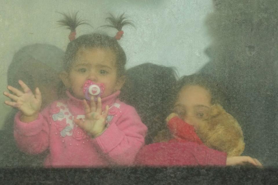 Refugee children look out from a bus leaving to Romania after fleeing the war from neighboring Ukraine, at the border crossing in Palanca, Moldova (AP)