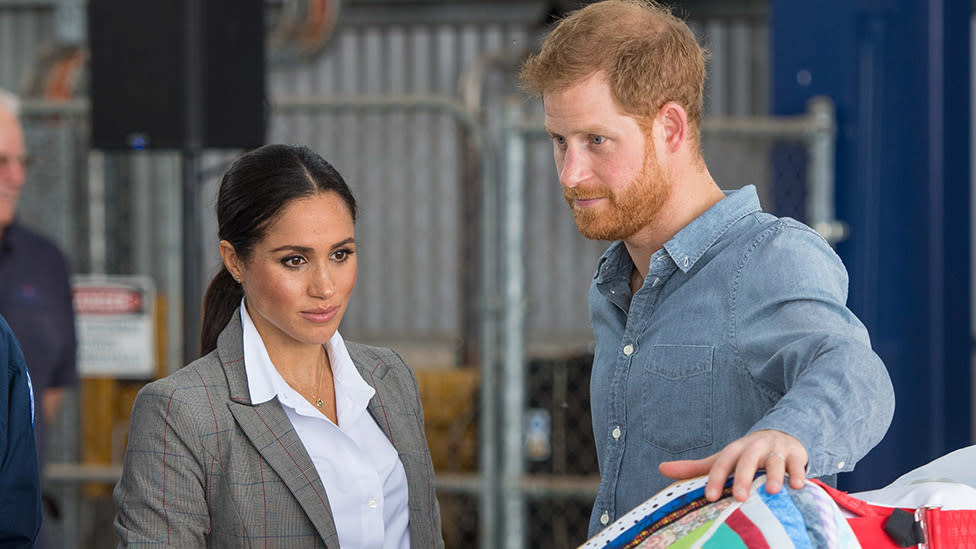 Meghan looks concerned, Harry rests hand on dummy in Dubbo Australia