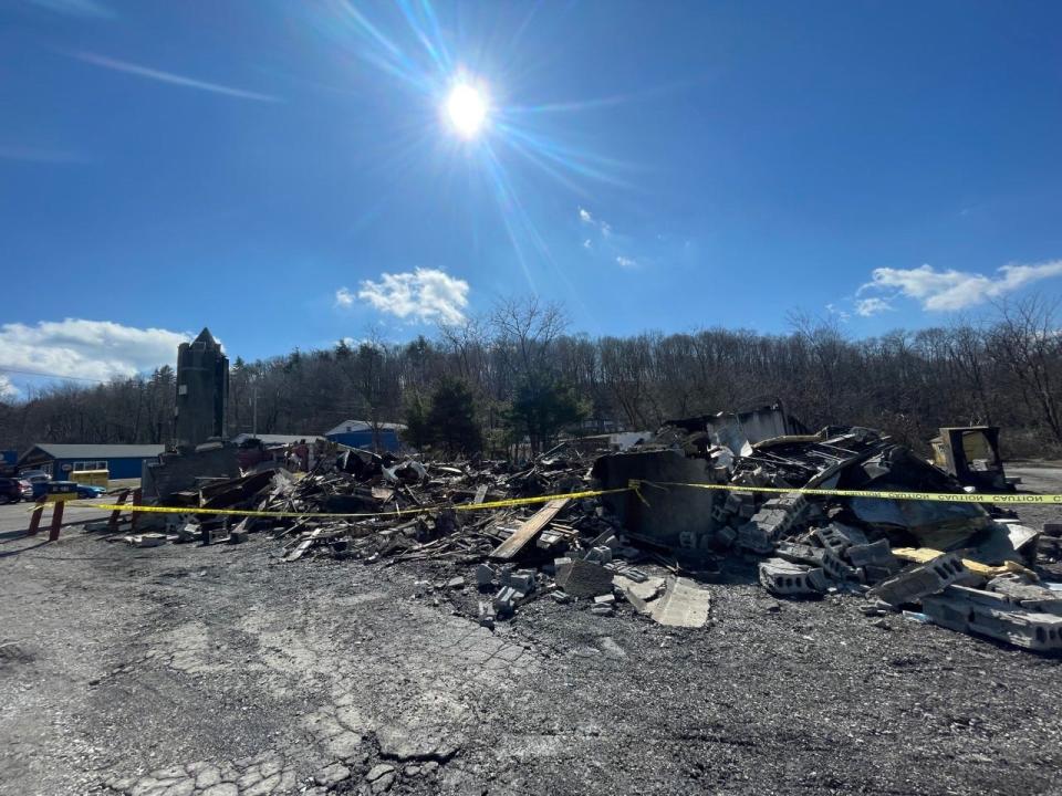 The walls of the Kings & Queens Restaurant and Pub, 4533 Lincoln Highway, were rocking, so a excavator was called in to take down what was left of the building after the fire Saturday.