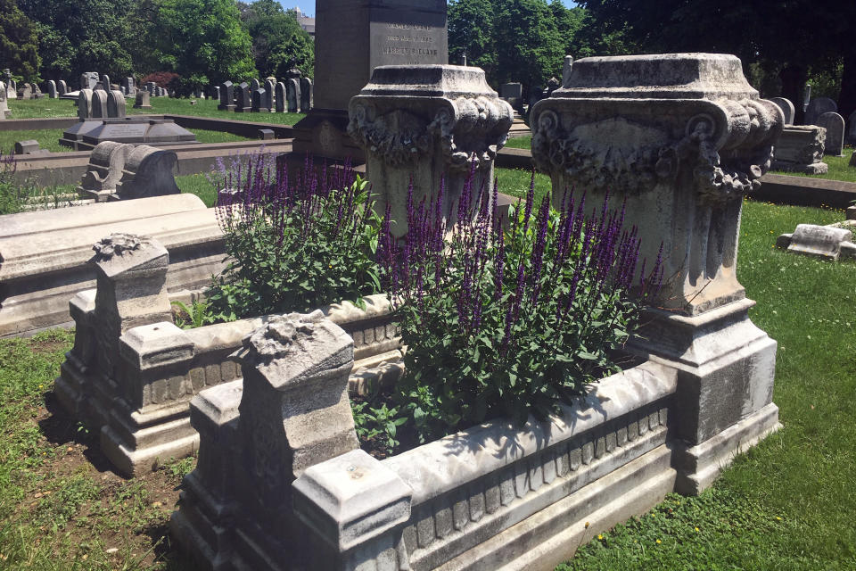 This undated photo, provided by Sherry Weller, shows two cradle graves at The Woodlands Cemetery in West Philadelphia. Weller is part of the Grave Gardeners program, where volunteers plant and maintain the cradle graves. (Sherry Weller via AP)