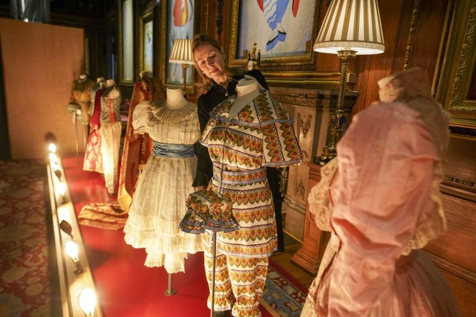 Royal Collection Trust curator Caroline de Guitaut puts the finishing touches to The Princesses’ Pantomimes costume display at Windsor Castle (Steve Parsons/PA) (PA Wire)