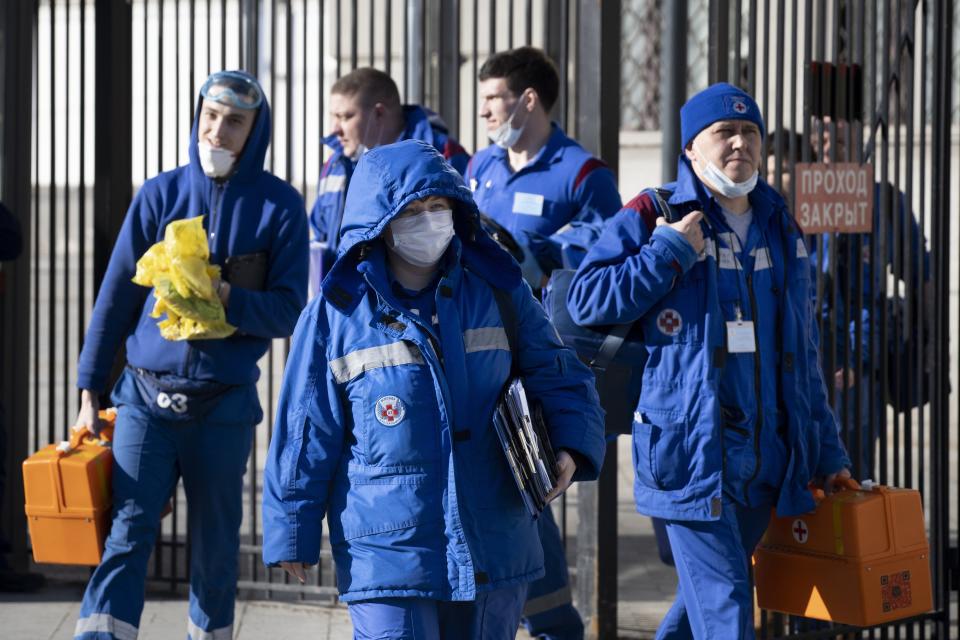 In this photo taken on Friday, Feb. 21, 2020, Medical workers walk after checking passengers where a passenger was identified with suspected coronavirus after arriving from Kyiv at Kievsky (Kyiv's) rail station in Moscow, Russia. Russia suspended all trains to China and North Korea, shut down its land border with China and Mongolia and extended a school vacation for Chinese students until March 1. Russian authorities are going to great lengths to prevent the new coronavirus from spreading in the capital and elsewhere. (AP Photo/Alexander Zemlianichenko)