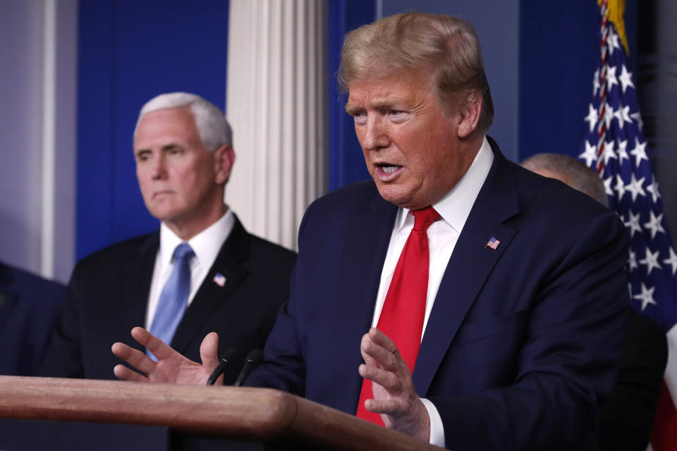 President Donald Trump speaks about the coronavirus in the James Brady Briefing Room, Tuesday, March 24, 2020, in Washington, as Vice President Mike Pence listens. (AP Photo/Alex Brandon)