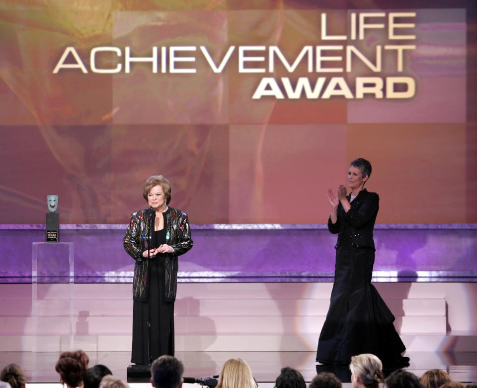 In this Sunday, Jan. 29, 2006, file photo, Jamie Lee Curtis, right, applauds as Shirley Temple Black accepts the Screen Actors Guild Awards annual Life Achievement Award at the Annual Screen Actors Guild Awards, in Los Angeles. Temple, who died at her home near San Francisco, Monday, Feb. 10, 2014, at 85, sang, danced, sobbed and grinned her way into the hearts of Depression-era moviegoers and remains the ultimate child star decades later. (AP Photo/Mark J. Terrill, File)