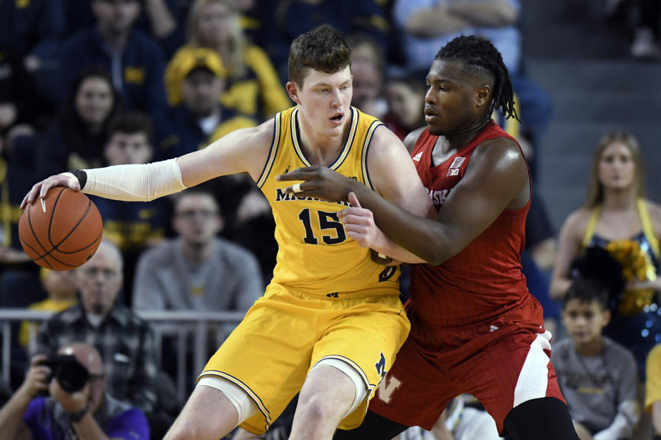 Michigan center Jon Teske, left, is guarded by Nebraska forward Yvan Ouedraogo during the first half of an NCAA college basketball game Thursday, March 5, 2020, in Ann Arbor, Mich. (AP Photo/Jose Juarez)