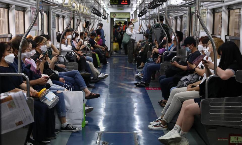 South Koreans wear masks on the subway to protect themselves against the spread of coronavirus.