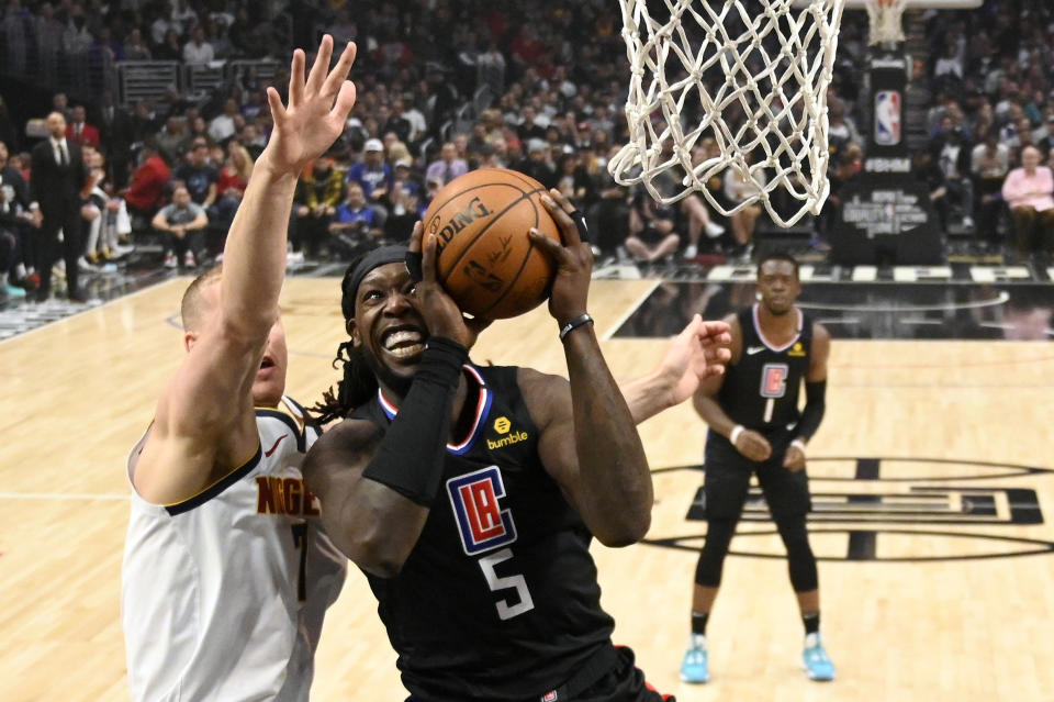 Los Angeles Clippers forward Montrezl Harrell, right, shoots as Denver Nuggets forward Mason Plumlee defends during the first half of an NBA basketball game Friday, Feb. 28, 2020, in Los Angeles. (AP Photo/Mark J. Terrill)