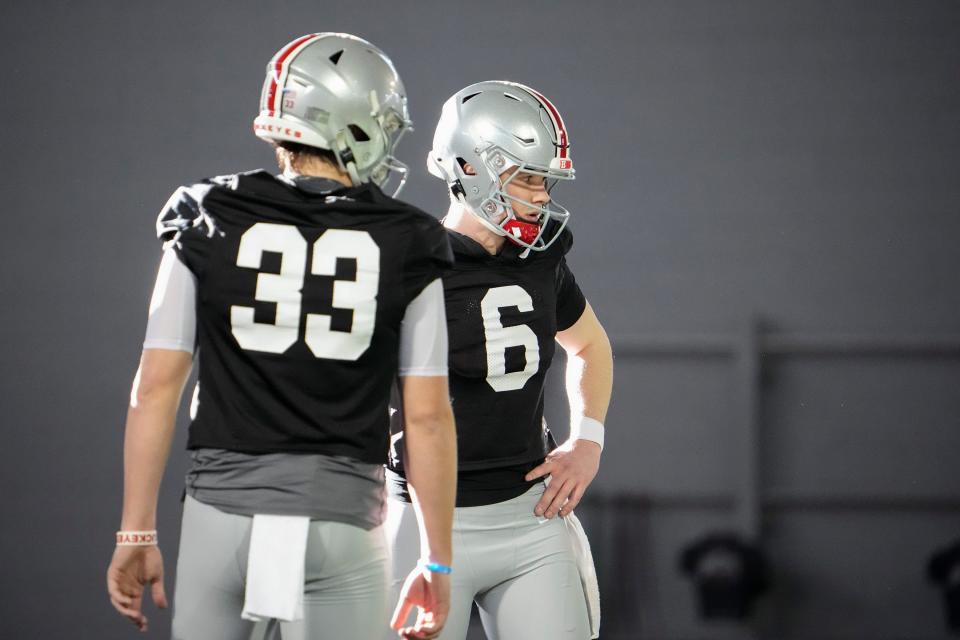 Mar 9, 2023; Columbus, Ohio, USA;  Ohio State Buckeyes quarterback Devin Brown (33) and quarterback Kyle McCord (6) wait to throw during spring football practice at the Woody Hayes Athletic Center. Mandatory Credit: Adam Cairns-The Columbus Dispatch