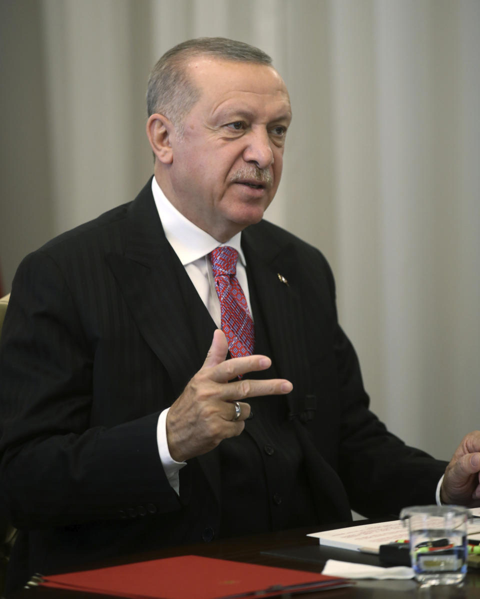 Turkey's President Recep Tayyip Erdogan speaks to the members of his ruling party in a televised address, in Ankara, Turkey, Wednesday, July 1, 2020. Erdogan vowed on Wednesday to tighten government control over social media, following alleged insults on Twitter to his daughter and son-in-law who announced the birth of their fourth child on the website. (Presidential Press Service via AP, Pool)