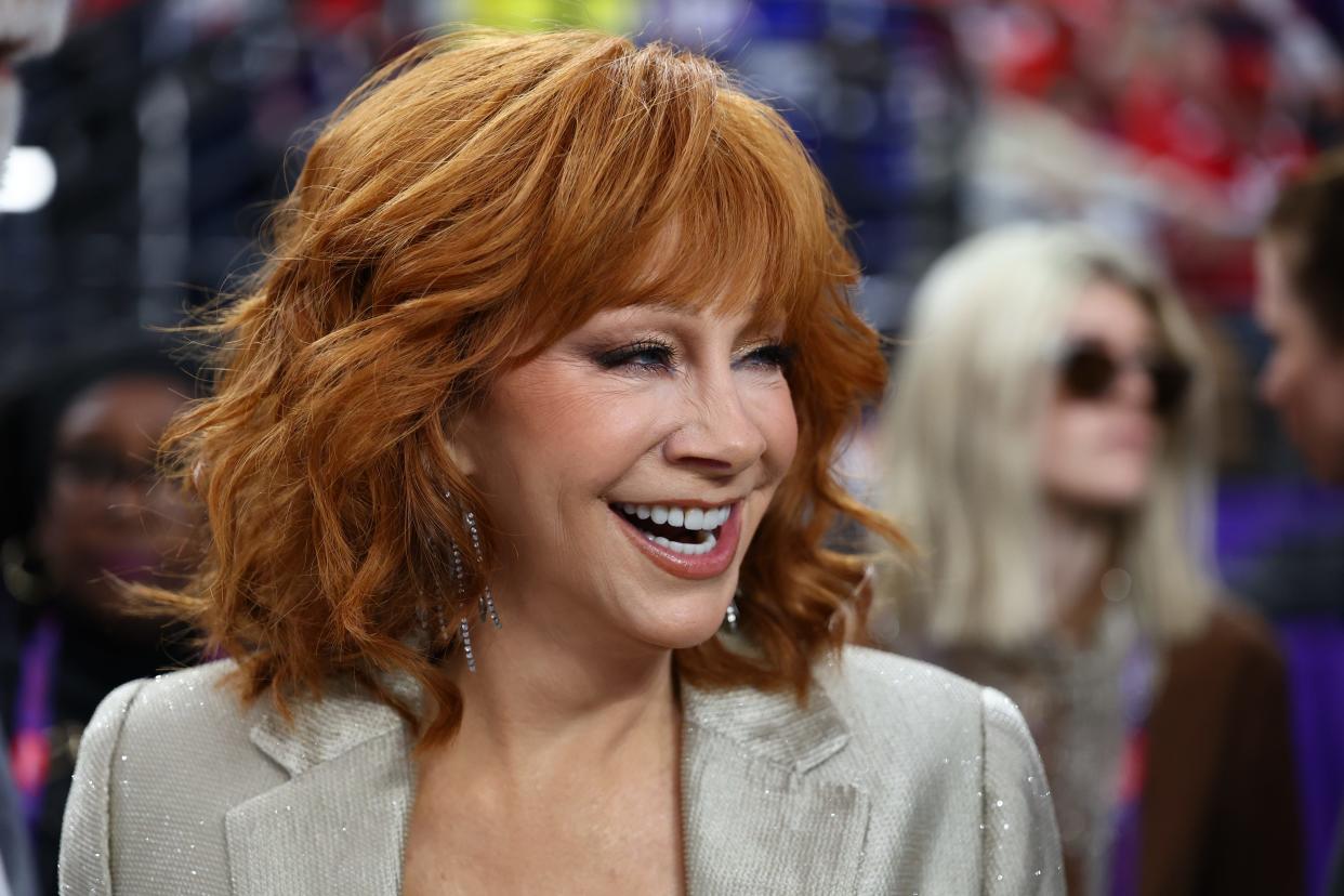 Recording artist Reba McEntire on the field before Super Bowl LVIII between the Kansas City Chiefs and the San Francisco 49ers at Allegiant Stadium.