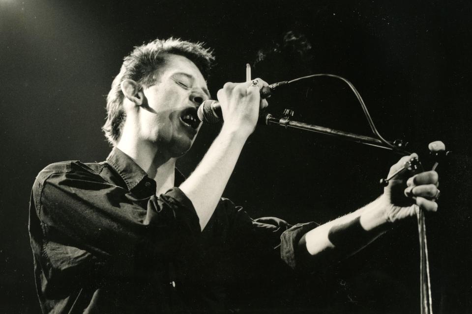 Pictured performing with The Pogues in 1985 (Alamy)