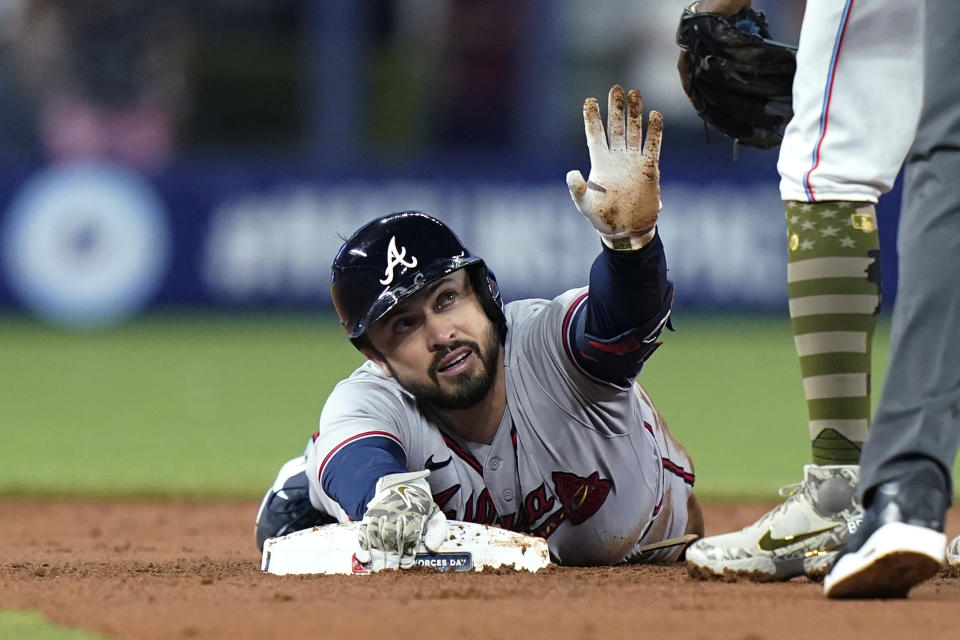 Atlanta Braves' Travis d'Arnaud is safe at second with a double during the first inning of the team's baseball game against the Miami Marlins, Friday, May 20, 2022, in Miami. (AP Photo/Lynne Sladky)