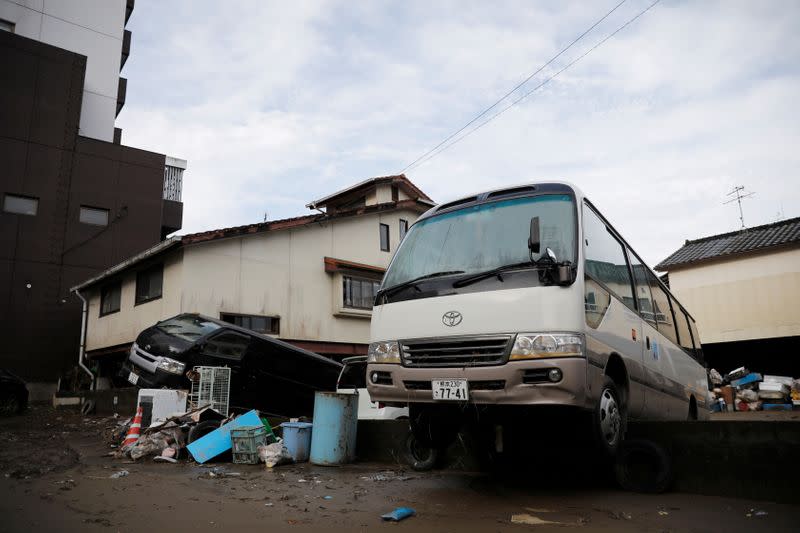 A van and a bus seen off the ground after floods caused by torrential rain in Hitoyoshi, Kumamoto Prefecture,