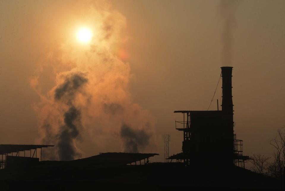 Smoke rises from a factory chimney. Photo: NARINDER NANU/AFP/Getty Images