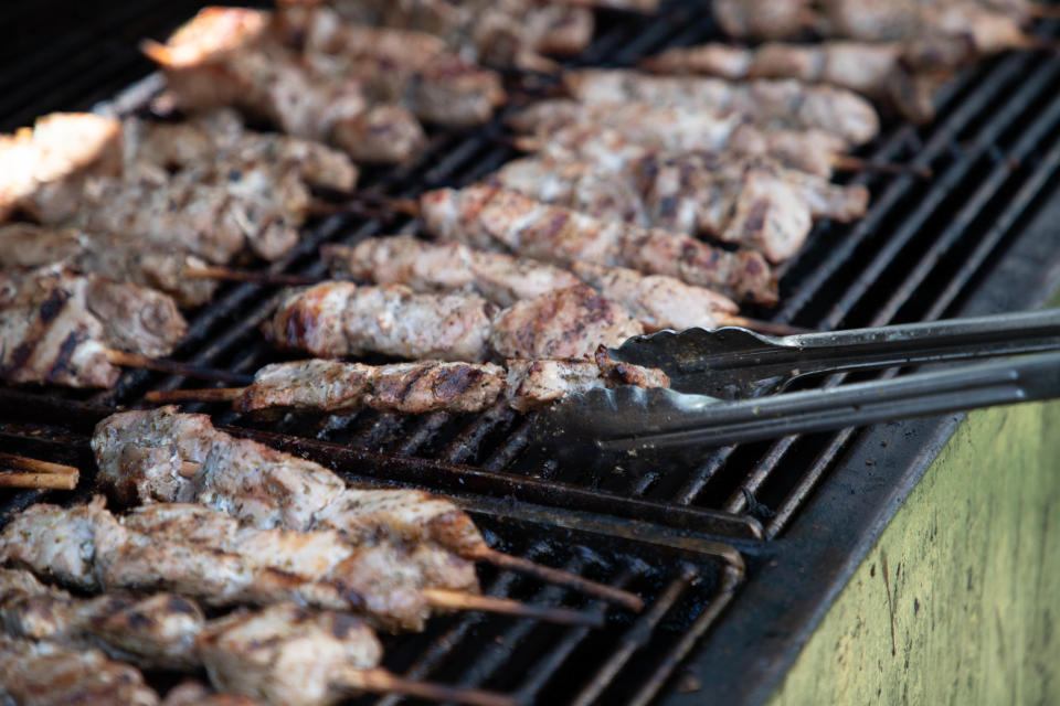 Tallahassee Greek Festival souvlaki chair George Joanos cooks the meat on a grill during the festival at Holy Mother of God Greek Orthodox Church Saturday, Oct. 16, 2021. 