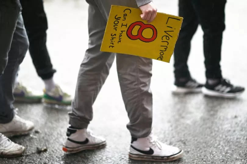 A Watford fan with a sign begging for Jake Livermore's shirt