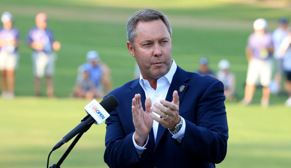   Whan claps his hands at the Women's US Open 