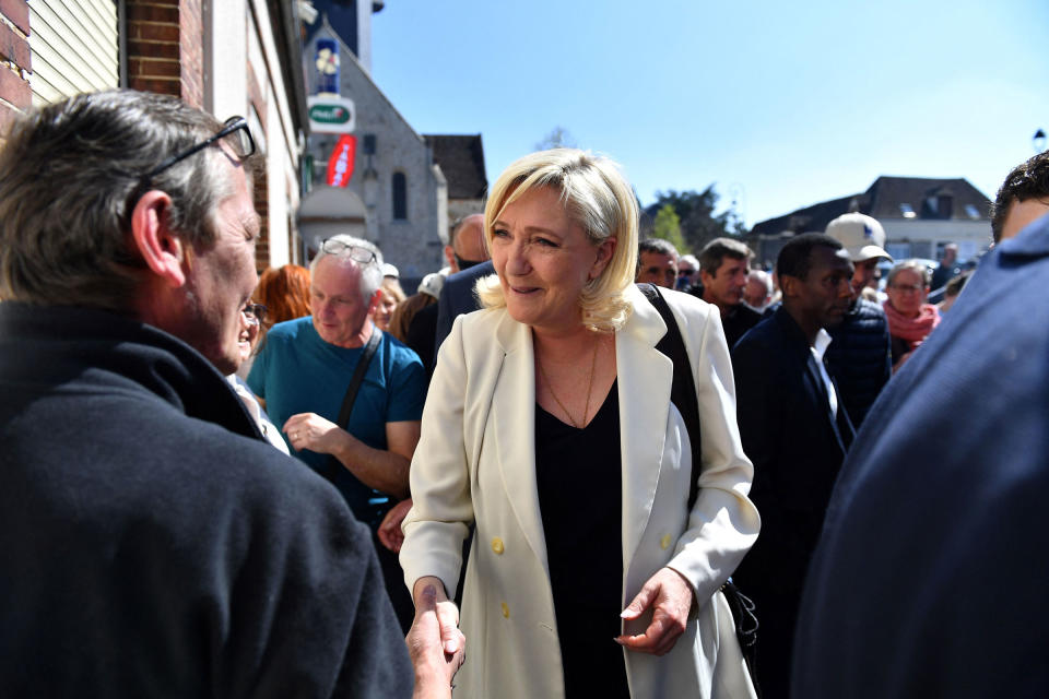 French far-right Rassemblement National (RN) party Member of Parliament and presidential candidate Marine Le Pen shakes hands with a member of the public during a campaign visit to Saint-Remy-sur-Avre, northwestern France, on April 16.<span class="copyright">Julien de Rosa—AFP/Getty Images</span>