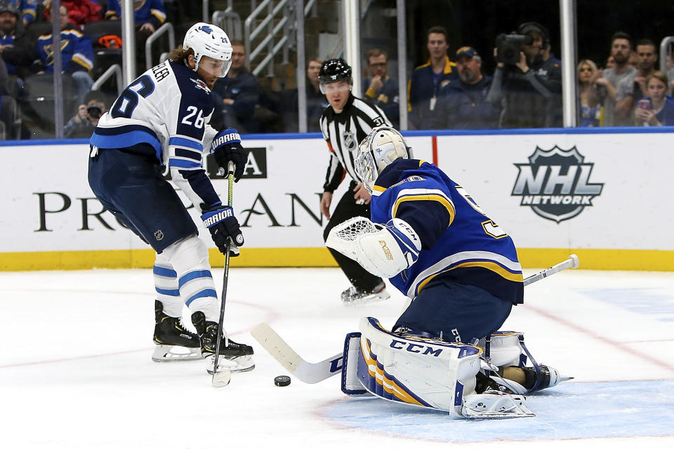 Winnipeg Jets' Blake Wheeler (26) is unable to score against St. Louis Blues goaltender Jordan Binnington (50) during the first period of an NHL hockey game Thursday Feb. 6, 2020, in St. Louis. (AP Photo/Scott Kane)