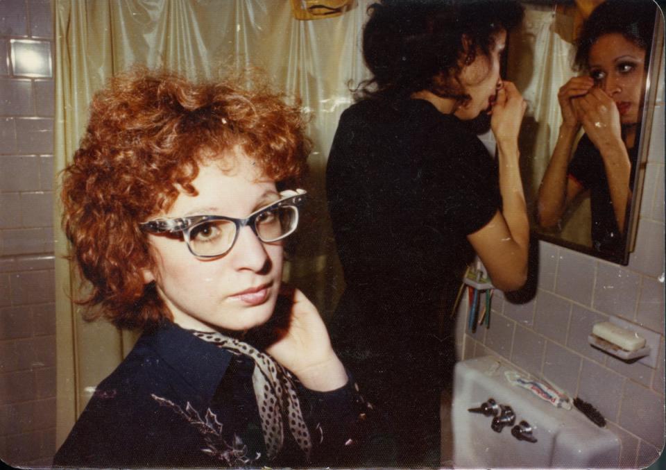 Nan in the bathroom with roommate, Boston, 1970s