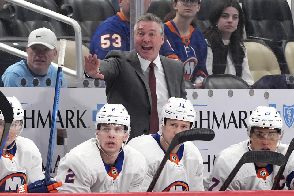 FILE - New York Islanders head coach Patrick Roy gives instructions from behind his bench during the second period of an NHL hockey game against the Pittsburgh Penguins in Pittsburgh, Tuesday, Feb. 20, 2024. The Islanders won 5-4. Of the 16 teams entering the NHL playoffs this weekend, seven feature coaches who are in their first full year or hired as midseason replacements. (AP Photo/Gene Puskar, File)