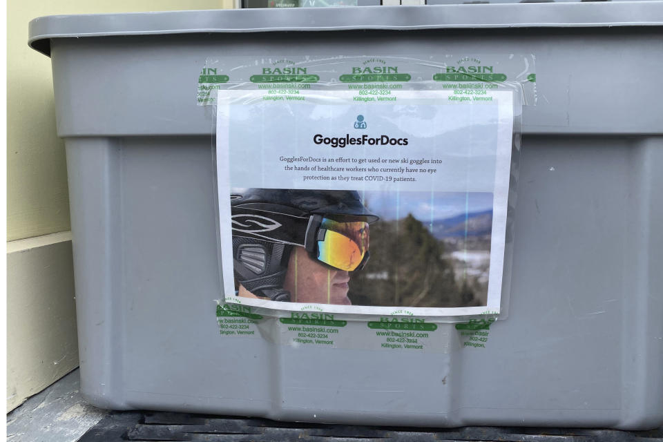 This Thursday April 2, 2020, photo provided by GogglesForDocs shows a bin for collecting new and used ski goggles outside Basin Sports in Killington, Vt. Olympic athletes, recreational skiers/snowboarders and businesses are rounding up as many new or used snow goggles with one clear vision: To aid those in the medical community who are in need of eye protection as they treat patients with COVID-19. It's part of a program called “Goggles for Docs," a grassroots effort that began in late March. (GogglesForDocs via AP)