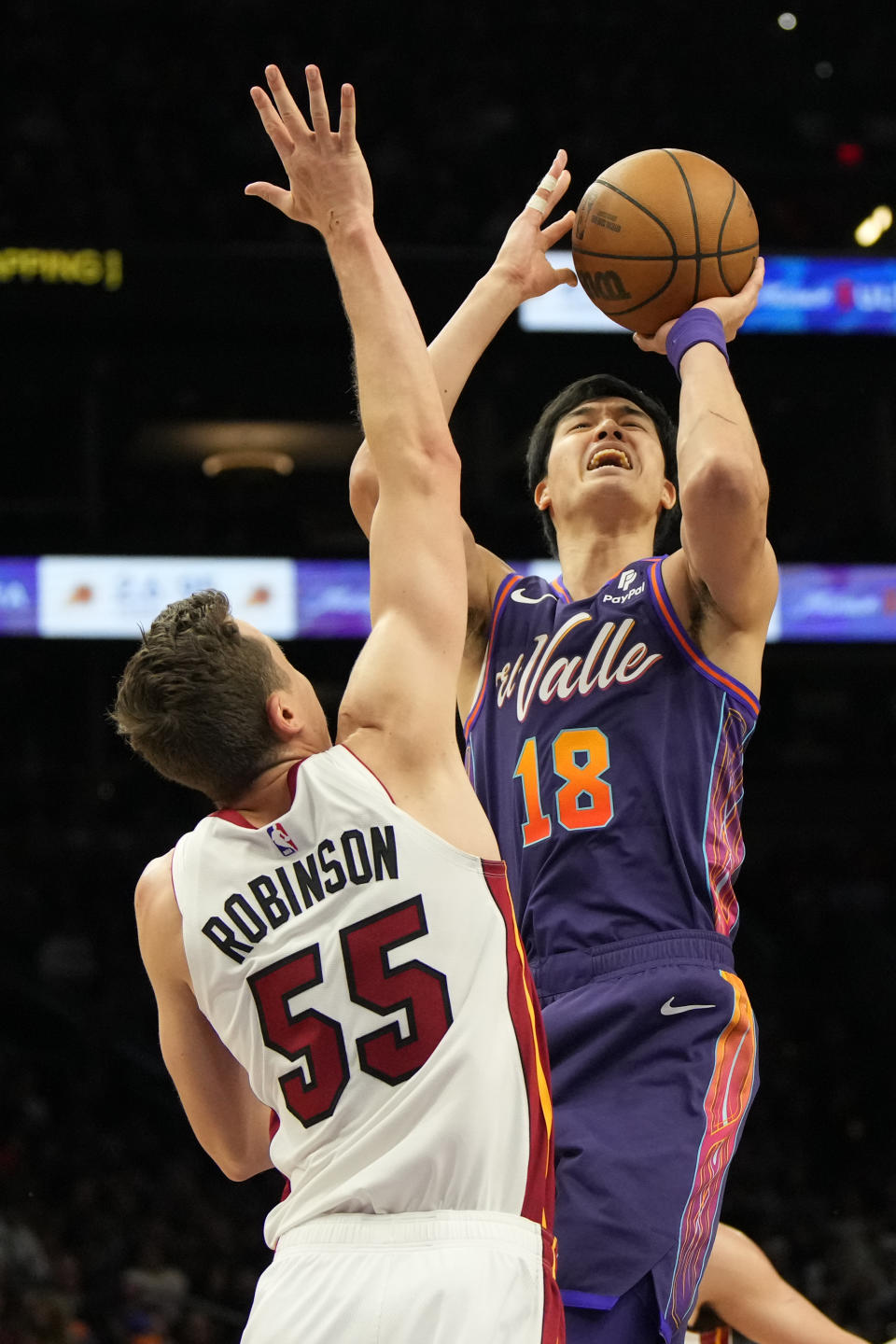 Phoenix Suns forward Yuta Watanabe (18) shoots over Miami Heat forward Duncan Robinson (55) during the first half of an NBA basketball game, Friday, Jan. 5, 2024, in Phoenix. (AP Photo/Rick Scuteri)