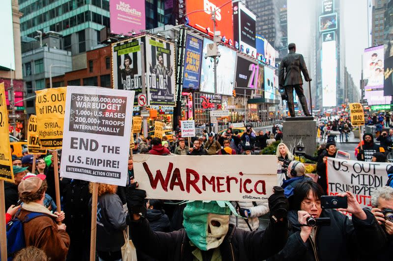 People take part in an anti-war protest amid increased tensions between the United States and Iran at Times Square in New York