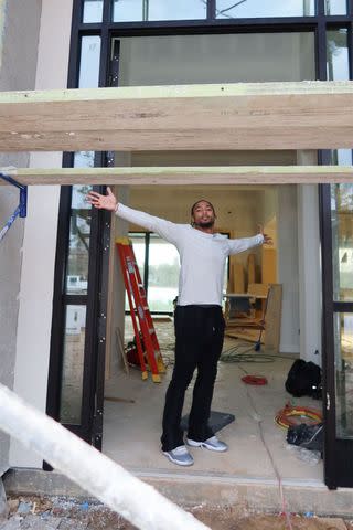 <p>simone biles/instagram</p> Jonathan Owens standing in the doorway of their home