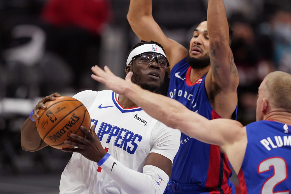 LA Clippers guard Reggie Jackson drives as Detroit Pistons center Mason Plumlee (24) and guard Cory Joseph defend during the first half of an NBA basketball game, Wednesday, April 14, 2021, in Detroit. (AP Photo/Carlos Osorio)