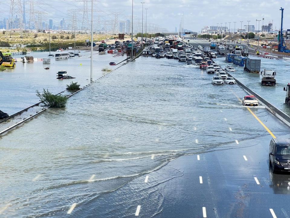 Vehicles stranded on a flooded road in Dubai (REUTERS)