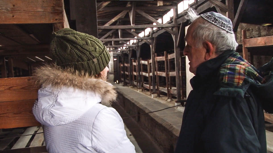 Rachel and her Grandfather Karl Shapiro visit the wooden stable-barracks at Auschwitz-Birkenau in a scene in 