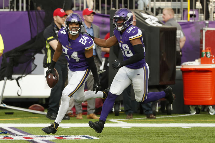 Minnesota Vikings safety Camryn Bynum (24) celebrates with teammate linebacker Jordan Hicks (58) after intercepting a pass during the second half of an NFL football game against the Arizona Cardinals, Sunday, Oct. 30, 2022, in Minneapolis. (AP Photo/Bruce Kluckhohn)