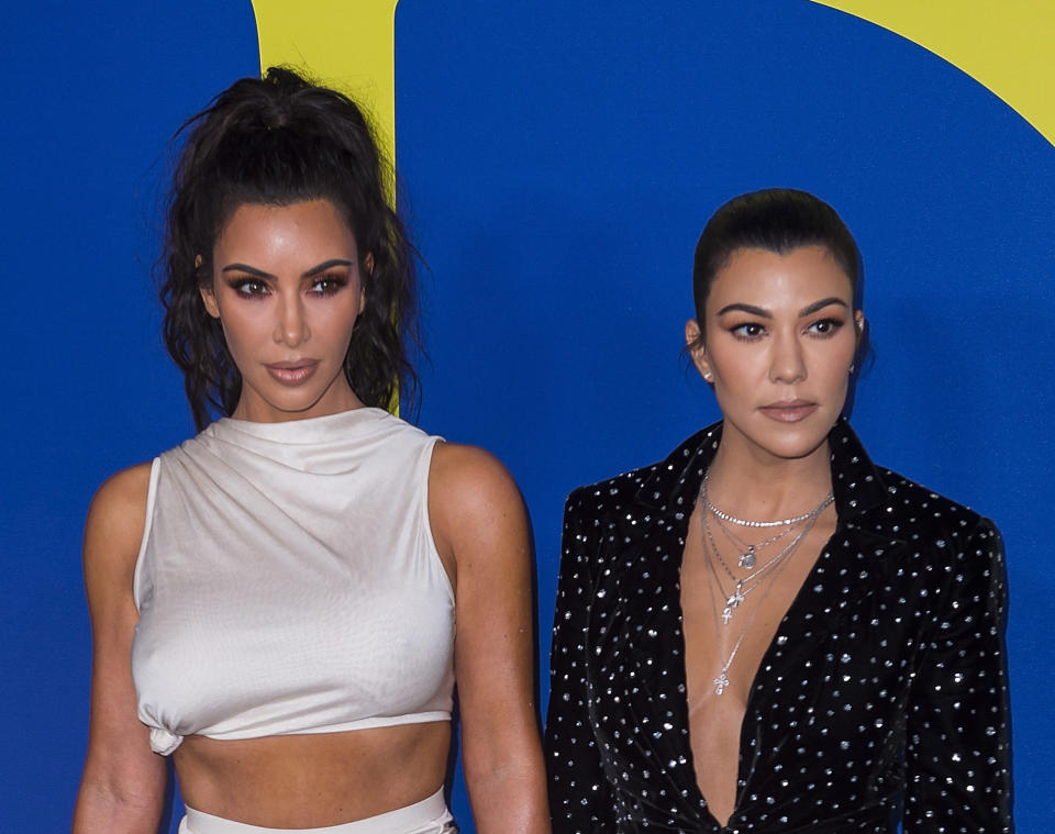 Kim Kardashian (left) and sister Kourtney Kardashian attend the annual Council of Fashion Designers of America awards show this June in New York.